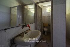 Sanitaires communs desservant tout un étage du sanatorium, carrelage fissuré et robinetterie ancienne